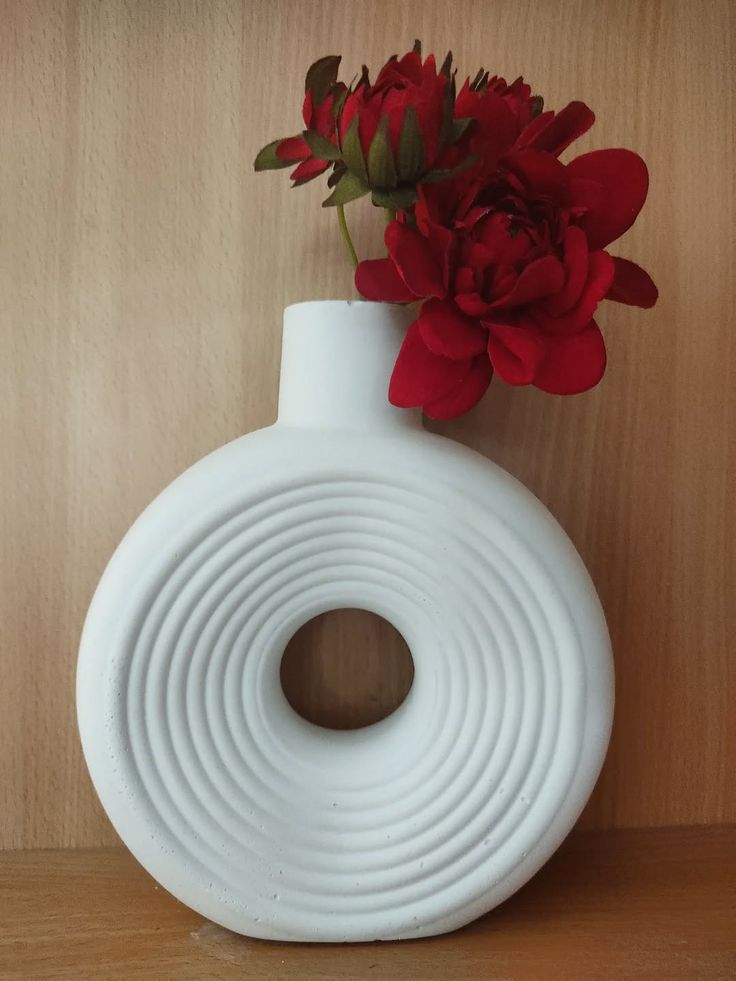 Concentric fluted ring donut vase with red florals