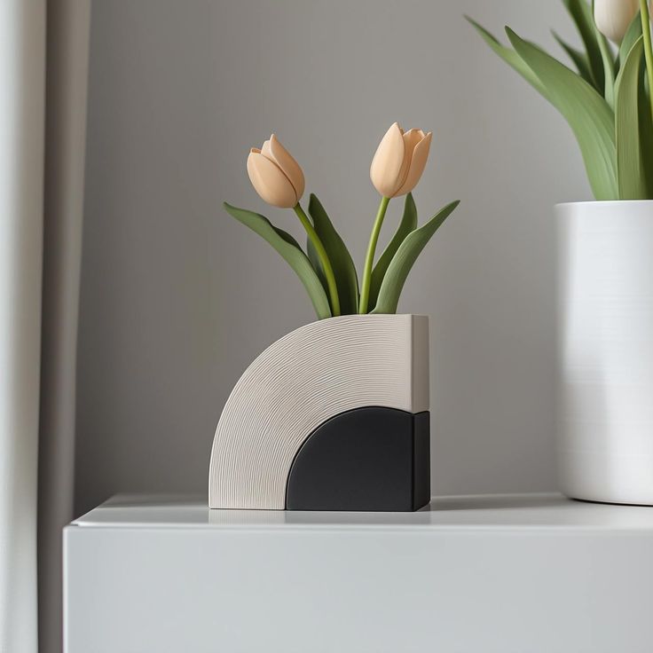 Art-deco fluted arch and black geometric quadrant vase with peach tulips