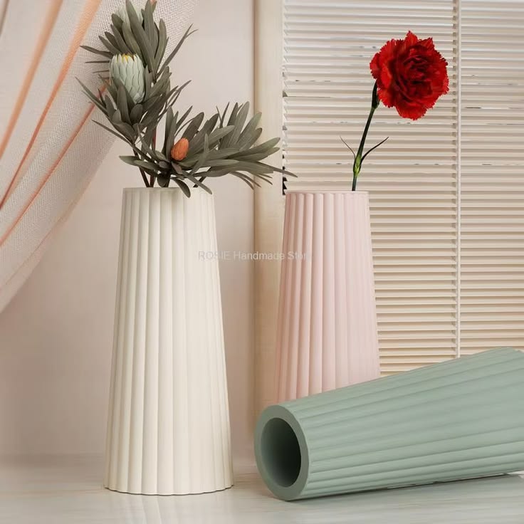 Trio of pastel fluted vases in cream, blush pink, and sage green